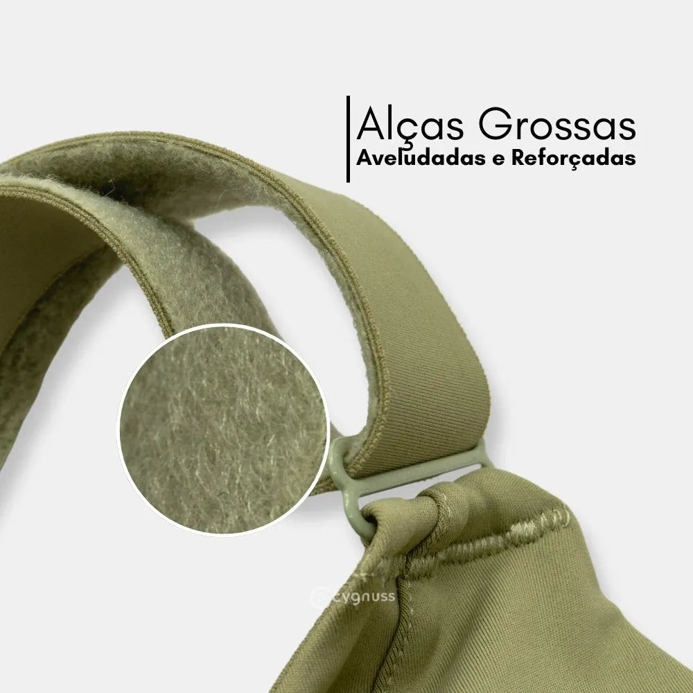 Detalhe das tirantes grossas y aveludadas do sostén esportivo Cygnuss, destacando o reforço y o comodidad do tejidos. A imagem inclui um zoom na textura interna, evidenciando a maciez y a qualidade do material.