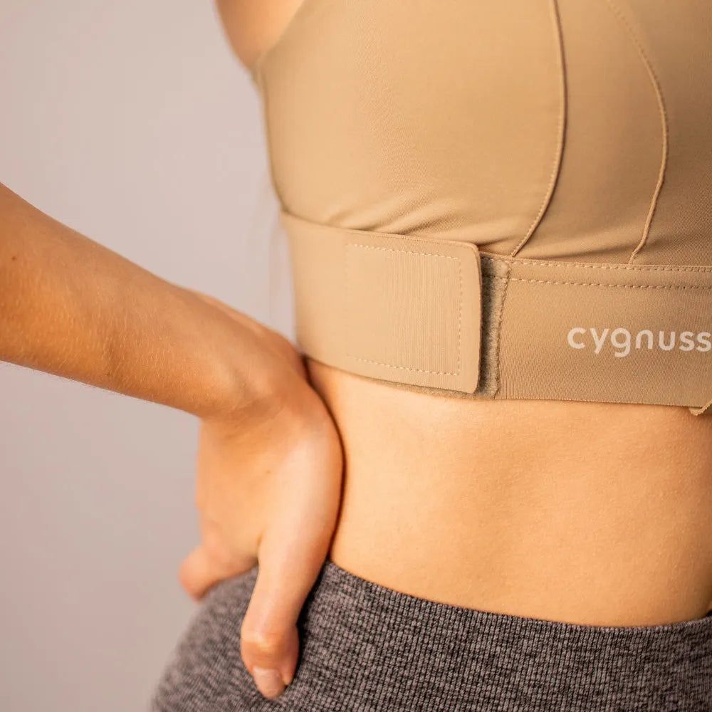 Detalhe do cierre ajustável do sostén esportivo Cygnuss, destacando a faixa elástica resistente y o ajuste preciso para melhor soporte y comodidad