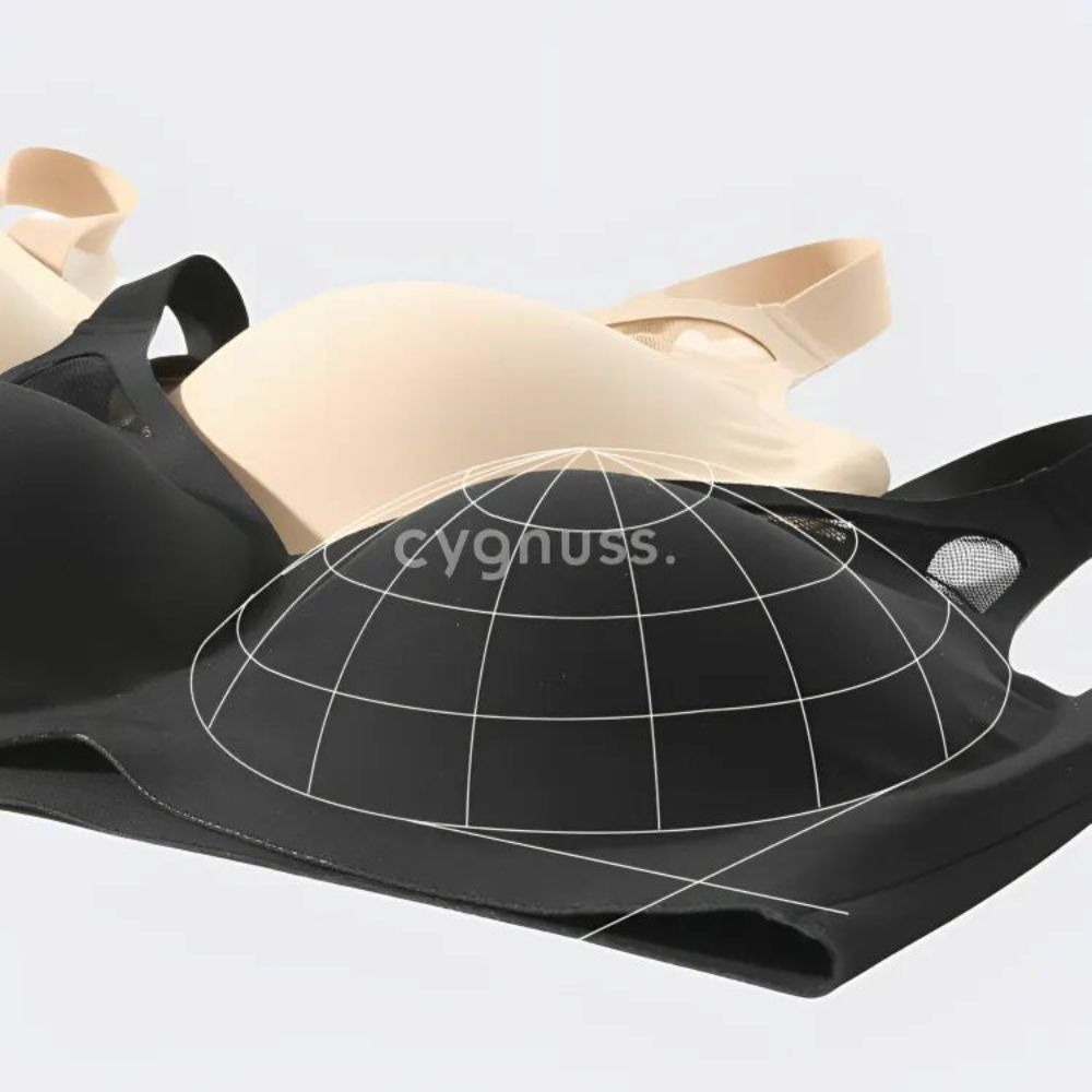 sostenes Cygnuss nas color preta y beige, destacando o design moldeador con estrutura anatômica que proporciona sustentação y formato arredondado aos seios.